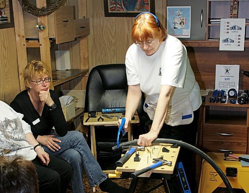 BORIS MINKEVICH / WINNIPEG FREE PRESS  070401 Tomboy Tools party. Tomboy Tools home consultant Diane Eisler,R, shows how to use a hacksaw at one of the meetings. The tools are designed for women by women.
