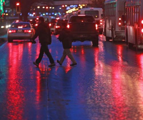 Sea of Light- Commuters run across the wet street at Portage and Carlton Wednesday morning-Those streets will freeze up later today as temperatures are to drop and bitter high winds are to prevail this afternoon in Winnipeg. Standup Photo- January 09, 2013   (JOE BRYKSA / WINNIPEG FREE PRESS)
