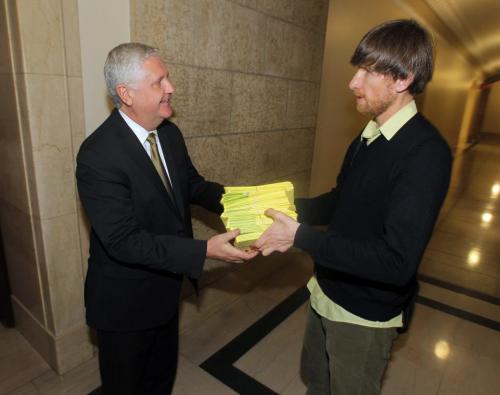 Wilderness Committee Campaign Director Eric Reder, right, gives more than 830 letters to Conservation Minister Gord Mackintosh in front of his office at the Leg. The group said thousands of Manitobans have also contacted the government, objecting to a planned peat strip mine in Hecla/Grindstone Provincial Park. January 9, 2013  BORIS MINKEVICH / WINNIPEG FREE PRESS