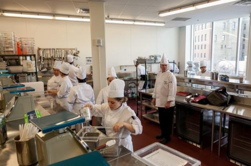 Students organize equipment in the Garde Manger Lab - a classroom kitchen for cold foods, including dishes like salads and sandwiches. Red River' College's new Paterson Global Foods Institute will officially open in February but classes have already started.  (Melissa Tait / WInnipeg Free Press)