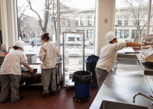 Students clean up in the Culinary Exchange kitchen on the main floor. Red River' College's new Paterson Global Foods Institute will officially open in February but classes have already started.  (Melissa Tait / WInnipeg Free Press)