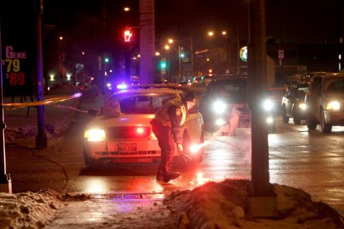 A Police Officer  re-ignites his flares at the corner of Century and Wellington blocking all north bound traffic due to a accident.  Jan 10, 2013.  (Ruth Bonneville /  Winnipeg Free Press)