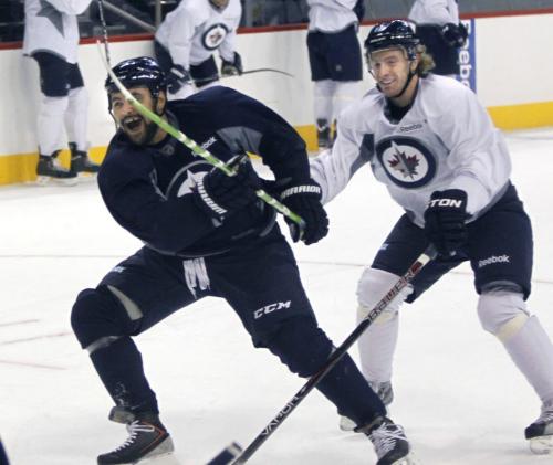 Winnipeg Jets players (left) Dustin Byfuglien and Bryan Little  at an informal practice in the MTS Centre Friday. Ed Tait/Tim Campbell story  (WAYNE GLOWACKI/WINNIPEG FREE PRESS) Winnipeg Free Press  Jan. 11 2013