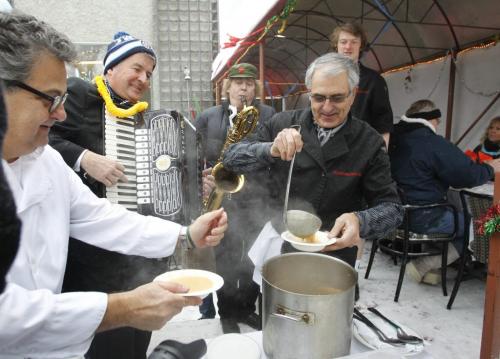 The wind was blowing as Arnaldo Carreira, owner of Orlando's Seafood Grill on Corydon serves up hot soup for the first course of the 30th anniversary Polar Bear Lunch held on the outdoor patio Friday with lively music supplied by Barry Gorlick on the accordion and Doug Wilson on sax. All proceeds raised went to the Manitoba Theatre For Young People.      (WAYNE GLOWACKI/WINNIPEG FREE PRESS) Winnipeg Free Press  Jan. 11 2013