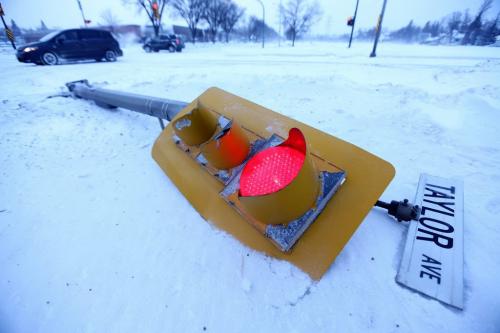 A traffic light sits on the ground at the corner of Harrow Street and Taylor Avenue after being struck by a car, Saturday, January, 2013. (TREVOR HAGAN/ WINNIPEG FREE PRESS)