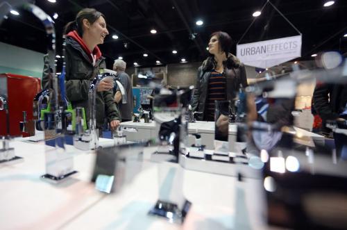 Trish Faurschou and Ahsley Brown near a display of faucets at the Winnipeg Convention Centre during the Kitchen, Bath and Renovation show, Saturday, January 12, 2013. (TREVOR HAGAN/WINNIPEG FREE PRESS)