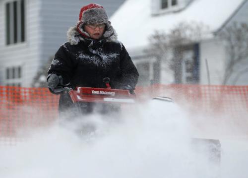 Kathleen clears snow from in front of her home in River Heights, Saturday, January 12, 2013. (TREVOR HAGAN/WINNIPEG FREE PRESS)