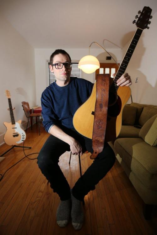 Matt Weinstein holds an acoustic guitar he found that belonged to Bill Edmondson who played with Neil Young in The Squires, Saturday, January 12, 2013. (TREVOR HAGAN/WINNIPEG FREE PRESS)