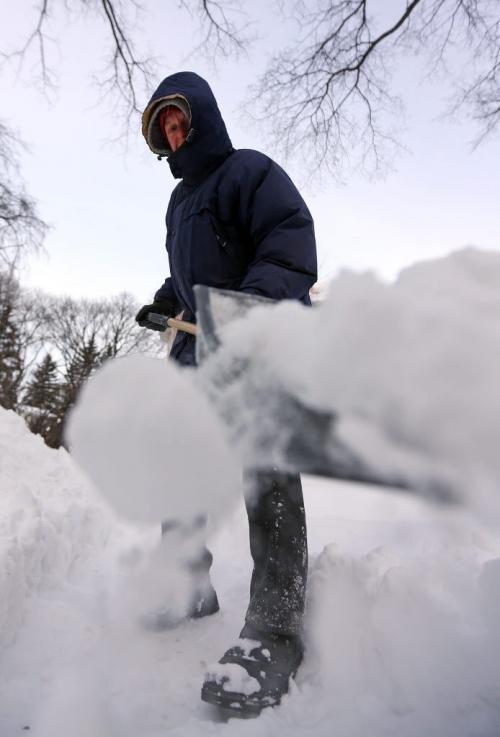 David Rozniatowski clears snow from in front of his home near the corner of McMillan Ave. and Cambridge St., Saturday, January 12, 2013. (TREVOR HAGAN/WINNIPEG FREE PRESS)