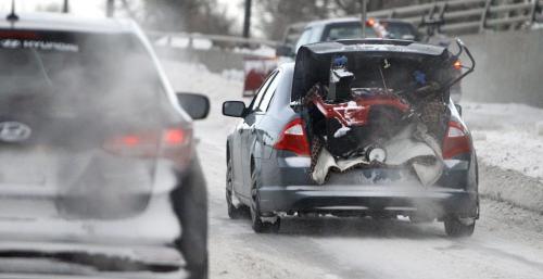 A person transports a large snowblower in the trunk of their over the bridge on Route 90, Saturday, January 12, 2013. (TREVOR HAGAN/WINNIPEG FREE PRESS)
