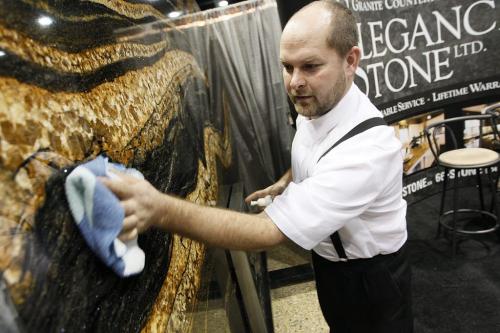 January 13, 2013 - 130113  -  Ed Wipf, manager and granite specialist of Elegance In Stone, a Maxwell Colony business venture, polishes some Brazilian Morambi Graniteat the Kitchen and Bath Show at the Convention Centre Sunday January 13, 2013.  John Woods / Winnipeg Free Press