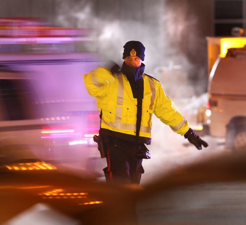Winnipeg Police Officers were out working on a cold case Monday morning with a temperature of -20C directing traffic on Portage Ave. at Fort St. after a a traffic light was knocked over.    (WAYNE GLOWACKI/WINNIPEG FREE PRESS) Winnipeg Free Press  Jan. 14 2013