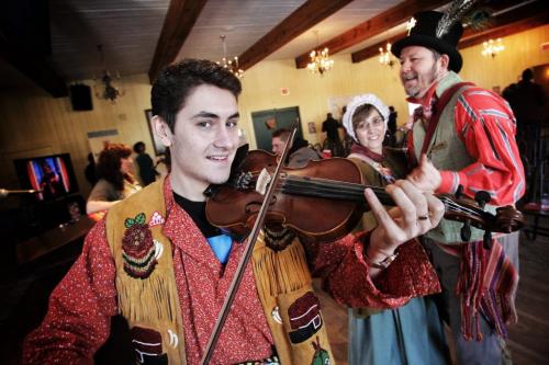 Festival du Voyageur performer Michael Audette plays a polka on his fiddle while members of the official Festival family do a quick dance during the progrmming announcement at Fort Gibraltar for the 2013 Festival du Voyageur.  130115 January 15, 2013 Mike Deal / Winnipeg Free Press