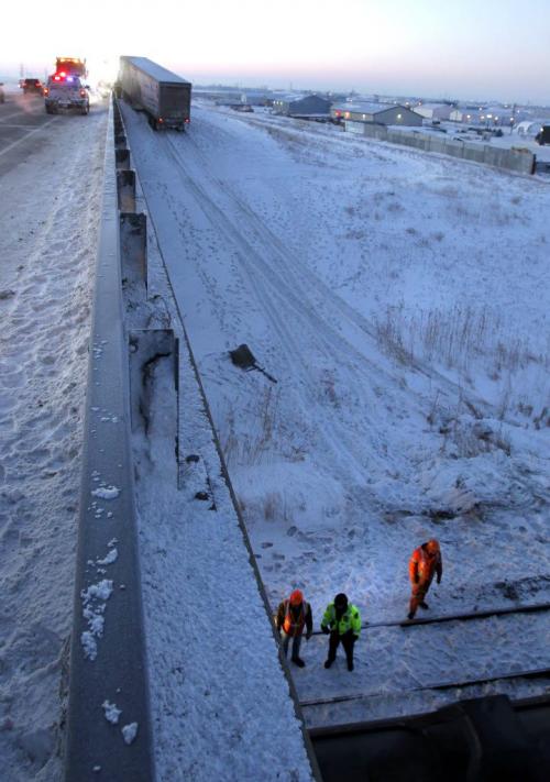 A semi-trailer is towed after it was heading southbound near Gunn Rd. and drove off the East Perimeter Highway Tuesday morning just prior to the rail overpass and continued down on to the rail tracks. A train struck the trailer.  (WAYNE GLOWACKI/WINNIPEG FREE PRESS) Winnipeg Free Press  Jan. 15 2013