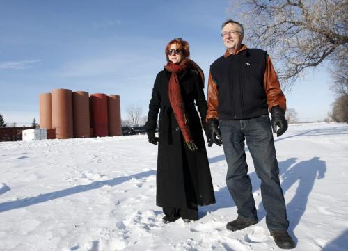 Wpg city council's property and development committee  voted to  uphold an order to remove eight metal silos from the rail yard  in area of Mathers Ave  and Lindsay St , in pic are residents  LtoR Debra  Black and Alain  Vermette are happy to see the silos go. KEN GIGLIOTTI / JAN 15 2013 / WINNIPEG FREE PRESS
