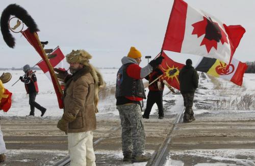 Protesters on the rail tracks near the Yellowhead Highway west of Portage la Prairie Wednesday after the CN train stopped about 1 km. away.   (WAYNE GLOWACKI/WINNIPEG FREE PRESS) Winnipeg Free Press  Jan. 16 2013