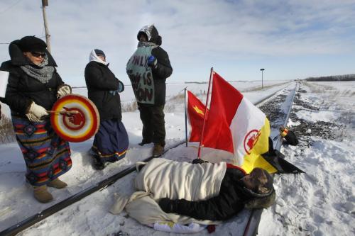 Percy Ballantyne lays on the rail tracks near the Yellowhead Highway west of Portage la Prairie Wednesday after the CN train stopped about 1 km. away, he and about 15 other protestors took part in demonstration. (WAYNE GLOWACKI/WINNIPEG FREE PRESS) Winnipeg Free Press  Jan. 16 2013