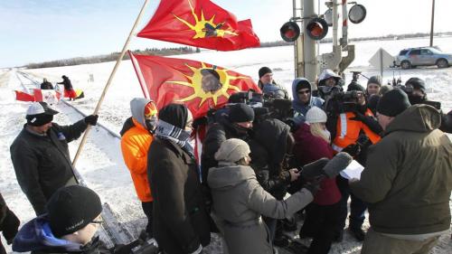 At right, the court injunction is read to protesters at the CN railway crossing on the Yellowhead Highway west of Portage la Prairie Wednesday afternoon.  (WAYNE GLOWACKI/WINNIPEG FREE PRESS) Winnipeg Free Press  Jan. 16 2013