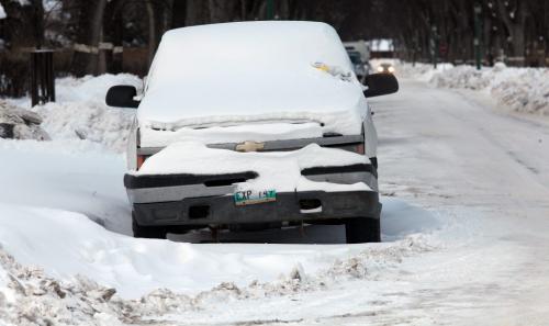 A snow covered vehicle in RIver Heights Wednesday, a ticket on it's windshield. Plows cleared around it despite the parking ban. See story re: ticketed owners and others who complained of poorly cleared streets. January 16th, 2013 - (Phil Hossack / Winnipeg Free Press)