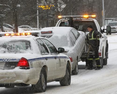 A vehicle is towed away from a scene Friday morning on Grant Ave. near Laidlaw Blvd. after two pedestrians were injured.   (WAYNE GLOWACKI/WINNIPEG FREE PRESS) Winnipeg Free Press  Jan. 18 2013