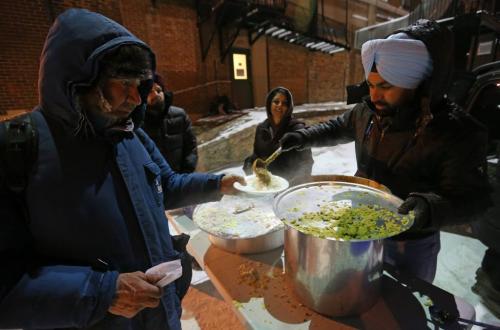 Kulwinder Sing Layal, right, a member of the Deshmesh Darbar Temple, serving food at a mobile soup kitchen behind the Siloam Mission, Saturday, January 19, 2013. Sikhs around the world celebrate Ruru Gobind Singh's birthday. (TREVOR HAGAN/WINNIPEG FREE PRESS)