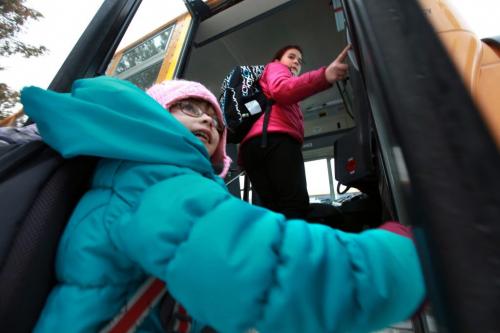 Reynolds School in the RM of Reynolds  a hour and a half east of Winnipeg has only 9 kids attending ithe school due to low enrollment. Celina Summerfeld (pink) and Latisha Smith get on their school bus at the end of their school day. See Nick Martin's story. Jan 16 2013, Ruth Bonneville  (Ruth Bonneville /  Winnipeg Free Press)