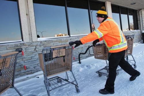 Safeway employee Angelo Santilli collects shopping carts in the frigid weather Monday afternoon.  130121 January 21, 2013 Mike Deal / Winnipeg Free Press