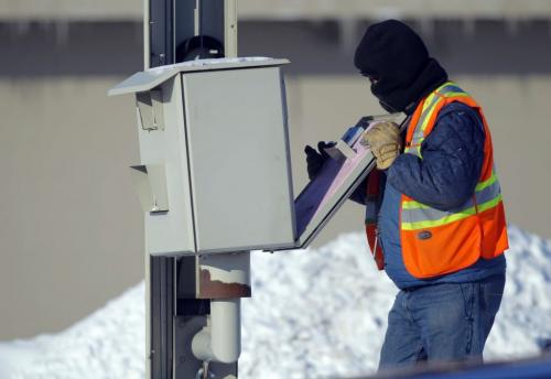 An contract worker for the City of Winnipeg services some red light cameras. This one was on Panet Road. He did not want to give his name but told the photographer that he moved to Winnipeg from Africa 8 years ago and was used to +41c. January 21, 2013  BORIS MINKEVICH / WINNIPEG FREE PRESS