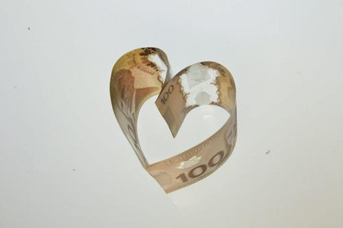 Canadian one hundred dollar bills in the shape of a heart to illustrate love, money and greed. 130122 January 22, 2013 Mike Deal / Winnipeg Free Press