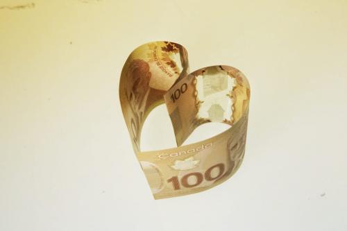 Canadian one hundred dollar bills in the shape of a heart to illustrate love, money and greed. 130122 January 22, 2013 Mike Deal / Winnipeg Free Press