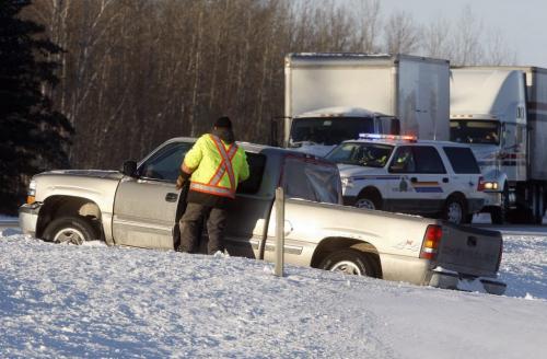 The investigation is incomplete at this time but it appears the driver of a pick up truck got stuck trying to cross the snow covered median between Hwy 1 , east and west bound lanes , that driver may have tried to flag down a semi for help when the driver of the pickup truck was struck and killed Äì in pic tow truck operator begins to pull pick up from median strip where it got stuck ,just short of the east bound Hwy 1 lane . Hwy one is now open to traffic east and west- the driver of the pickup has definitely  been killed -  KEN GIGLIOTTI / JAN. 23 2013 / WINNIPEG FREE PRESS