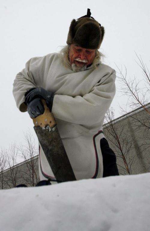 Fred Ford cutting snow blocks with hand saw learned to build igloos in  Baker Lake ( in white parka) and Zacharias  Kunuk   from Igloonik Nunavut  are building 2 ,  9ft by 7ft  tall igloos  on the roof top  patio of the WAG -Two igloos are being built  courtesy of the Mb. Urban Inuit Ass. , the public can visit the igloos  that coincide with the opening of Creation & TransformatioN:Defining Moments of Inuit Art  highlighting 115 works of inuit art from the WAG Collection KEN GIGLIOTTI / JAN. 24 2013 / WINNIPEG FREE PRESS