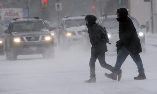 Stdup Weather - -22 with cold  and blowing  Snow falling on downtown Wpg , . Pic on Portage Ave at Memorial Blvd KEN GIGLIOTTI / JAN. 24 2013 / WINNIPEG FREE PRESS