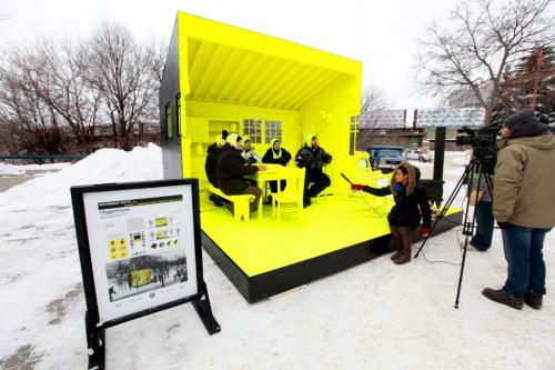 A team of Architects sit in their HyggeHouse,  a warming Hut  which is a cozy interior scene of  home painted completely flurorescent yellow to give the viewer a pychological experience of warmth.   See Randy Turner's story. Jan 24, 2013, Ruth Bonneville  (Ruth Bonneville /  Winnipeg Free Press)