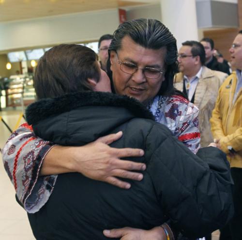 Raymond Robinson embraces his wife after he arrivied at James A. Richardson International Airport, Robinson ended a six week fast with Attawapiskat Chief Theresa Spence. Alex Paul story  (WAYNE GLOWACKI/WINNIPEG FREE PRESS) Winnipeg Free Press  Jan. 25 2013