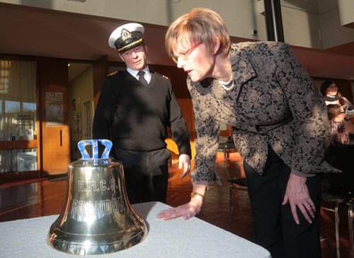 Brandon Sun Mayor Shari Decter Hirst takes a closer look at the inscribed names of children christened on the ship with Lt-Cmdr. Michael Sorsdal, former commanding officer of the HMCS Brandon, after the handing-over of the ship's bell at City Hall, on Friday morning. (Bruce Bumstead/Brandon Sun)