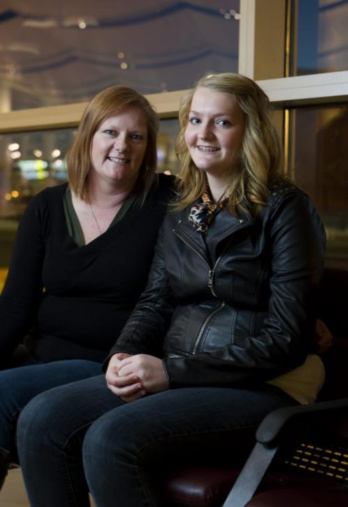 130125 Winnipeg - Georgia Burns, 16, and mom Ellen wait for their flight to Toronto Friday evening at the James Armstrong Richardson International airport. The two are flying down to  Toronto for an awards ceremony for an art contest. Georgia is one of the 177 winners (finalists) for the chance to see the painting she produced be one of 25 artworks to hang in the new childrenÄôs respiratory unit at the Herzog Hospital in Israel. The ceremony is on Sunday. DAVID LIPNOWSKI / WINNIPEG FREE PRESS.