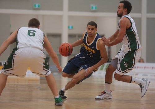 Brandon Sun Bobcats' Michael Smith looks for an opening between the Hiskies' defence during Saturday's university basketball game against the visiting U of S Huskies at the BU Healthy Living Centre. (Bruce Bumstead/Brandon Sun)