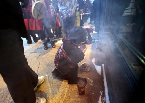 Tyrell Pelletier, attending the "idle no more" rally on the steps at Manitoba Legislature baths in the smoke of a traditional smudge. Several hundred protestors gathered Monday at the Legislature to attend the National Day of Protest. See Bart Kives story. January 28, 2013 - (Phil Hossack / Winnipeg Free Press)