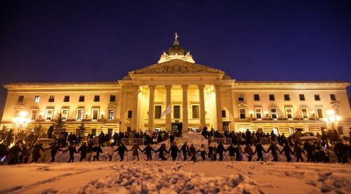 An Idle No More rally saw a massive round dance around part of the Manitoba Legislature and the statue of Queen Victoria Monday evening. Buffy Sainte-Marie spoke and sang for the crowd of several hundreds before the round dance. (Melissa Tait / Winnipeg Free Press)