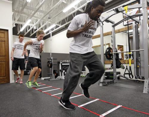 Victory Therapy  ,(right)  Blue Bomber Kito Poblah  helps train local high school football players (left )  Griffin Shillingford  of Kelvin , (centre) and Kellen Pooles  of Vincent Massey Äì ashley prest KEN GIGLIOTTI / JAN. 29 2013 / WINNIPEG FREE PRESS