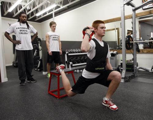 Victory Therapy  ,(left )  Blue Bomber Kito Poblah  helps train local high school football players (right)  Griffin Shillingford  of Kelvin , (centre) and Kellen Pooles  of Vincent Massey Äì ashley prest KEN GIGLIOTTI / JAN. 29 2013 / WINNIPEG FREE PRESS