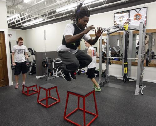 Victory Therapy  ,(right foreground )  Blue Bomber Kito Poblah  helps train local high school football players (left)  Griffin Shillingford  of Kelvin , (rear right ) and Kellen Pooles  of Vincent Massey Äì ashley prest KEN GIGLIOTTI / JAN. 29 2013 / WINNIPEG FREE PRESS