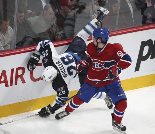 Winnipeg Jets' Blake Wheeler (L) is checked by Montreal Canadiens' Raphael Diaz during the second period of their NHL hockey action in Montreal, January 29, 2013.  REUTERS/Christinne Muschi (CANADA - Tags: SPORT ICE HOCKEY) - RTR3D4YA