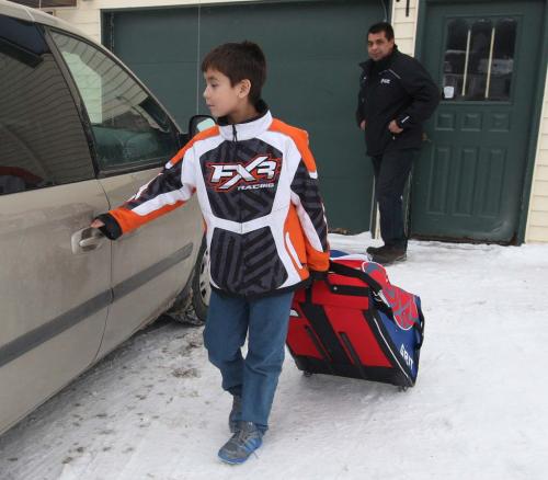 Warroad, Minnesota- 9 year old Daimon Gardner  leaves his home with his father Vince to the rink from their home in Warrod, Minnesota . He plays on the  Warrod squirt a team-See Randy Turners hockey FYI  story- January 29, 2013   (JOE BRYKSA / WINNIPEG FREE PRESS)