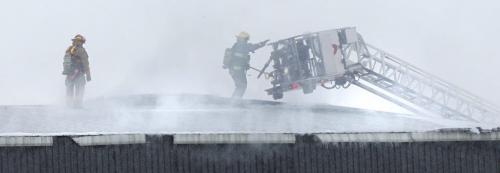 Winnipeg Fire Fighters on the roof of  a fire at EJR Reload Wednesday morning, the warehouse is located at 250 Sutherland Ave. Randy Turner story.  (WAYNE GLOWACKI/WINNIPEG FREE PRESS) Winnipeg Free Press  Jan.30  2013