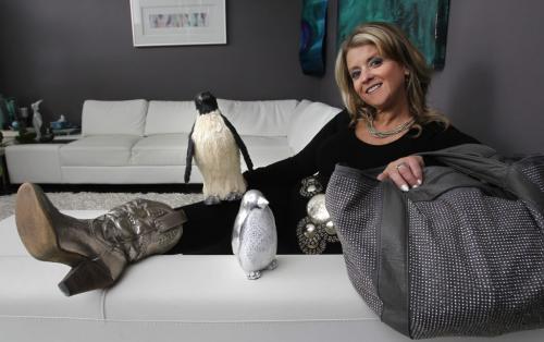 My Stuff, Detour. Lianne Tregobov with her purse, silver cowboy boots, white leather sectional and a couple of penguins from her collection. (WAYNE GLOWACKI/WINNIPEG FREE PRESS) Winnipeg Free Press  Jan.30  2013