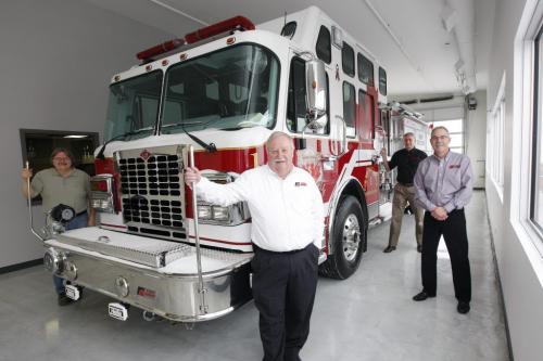 shop floor with several fire trucks being built - Fort Garry Fire Trucks new manufacturing plant on Bergen Cutoff Rd. , with company owner Rick Suche in photos centre , the company is rebranding to be the premier fire truck maker in North America Äì Martin Cash story - LtoR - Tony Berlis   , owener Rick Suche , Jim Peters  Operations Mgr. Brian Nash National sales Mgr  with brand new  fire truck for  Valcartier Que  KEN GIGLIOTTI / JAN. 30 2013 / WINNIPEG FREE PRESS