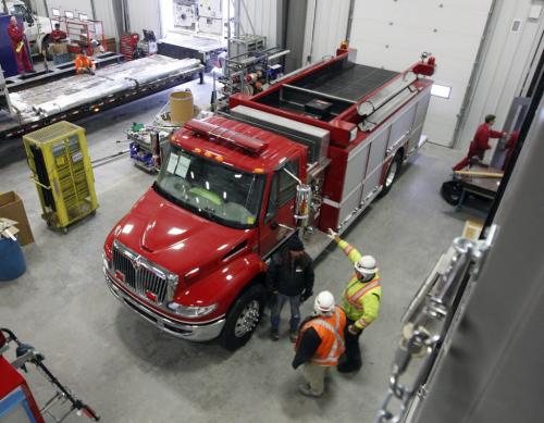 shop floor with several fire trucks being built - Fort Garry Fire Trucks new manufacturing plant on Bergen Cutoff Rd. , with company owner Rick Suche in some photos , the company is rebranding to be the premier fire truck maker in North America Äì Martin Cash story -  KEN GIGLIOTTI / JAN. 30 2013 / WINNIPEG FREE PRESS