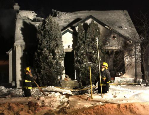 Winnipeg Fire Fighters at a home in the 1200 block of Fleet Ave. that was extensively damaged by an overnight fire.  (WAYNE GLOWACKI/WINNIPEG FREE PRESS) Winnipeg Free Press  Jan.31  2013